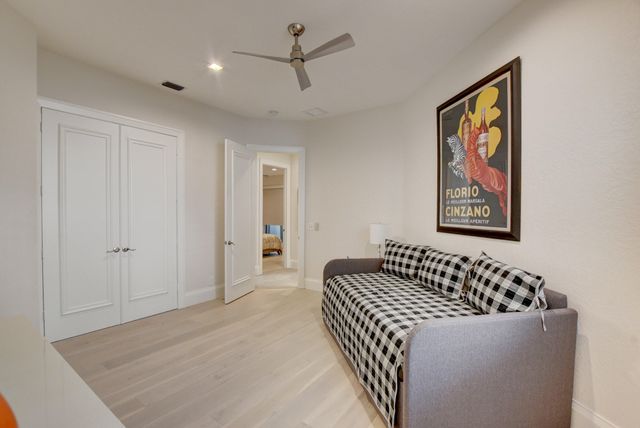 a living room with furniture and large windows