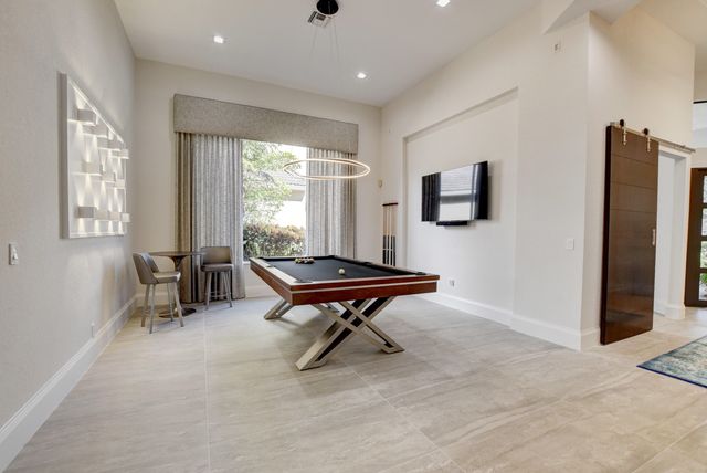 a bedroom with a large bed and a painting on the wall
