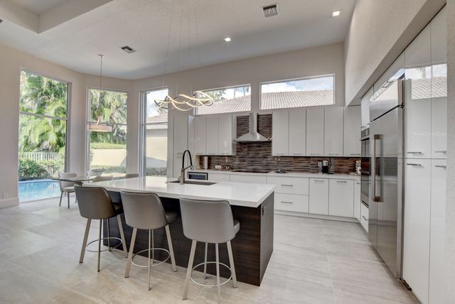 a view of a patio with couches chairs and potted plants