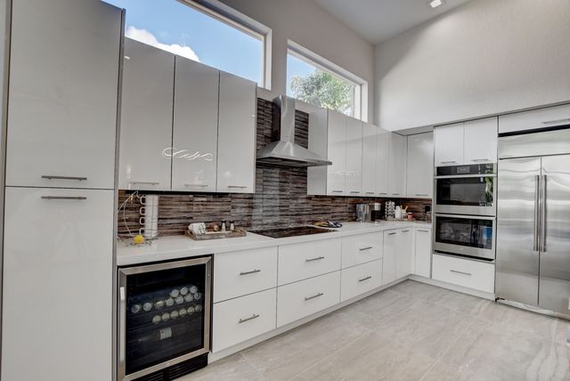a view of a swimming pool with outdoor seating and plants