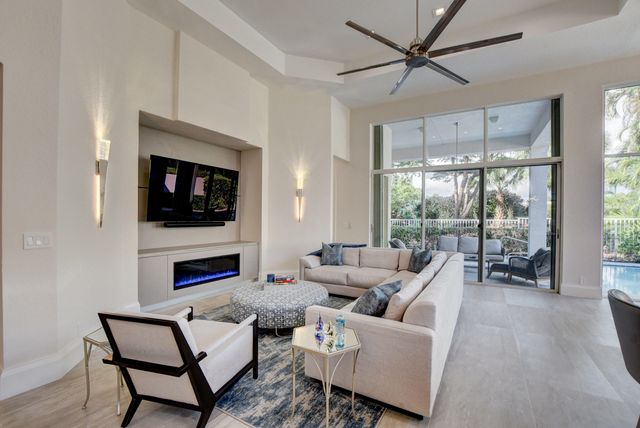 a view of a patio with dining table and chairs potted plants and palm trees