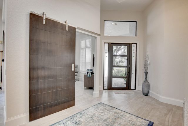 a room with furniture pool table flat screen tv and a large window