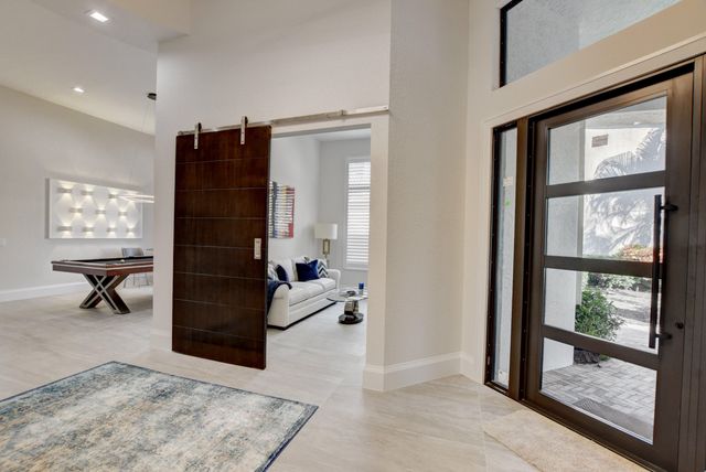 a living room with furniture a window and a flat screen tv