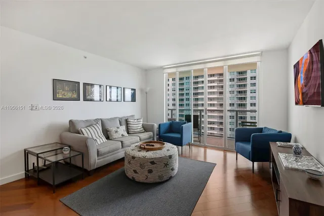 a living room with furniture and a large window