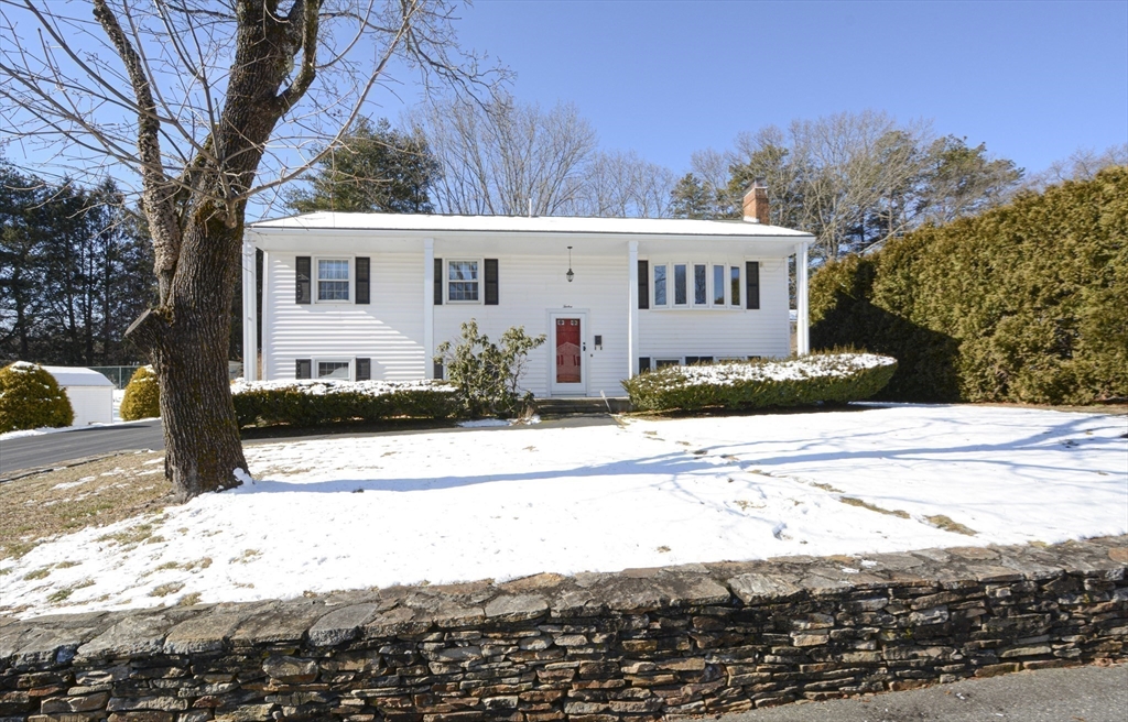 12 Ruthellen Road Hudson, MA 01749 - Photo 11 of 36 a view of a white house with a yard covered in snow