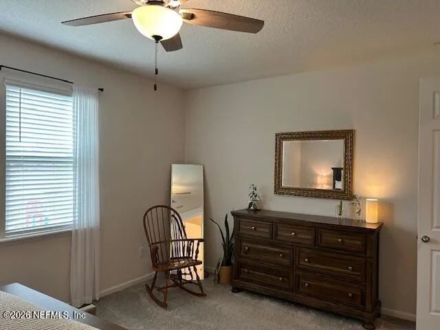 a room with a bed and a dresser