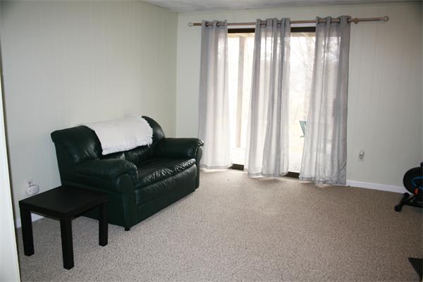 8 Apple Ridge Road, Unit 6 Maynard, MA 01754 - Photo 24 of 30 a living room with furniture and a window