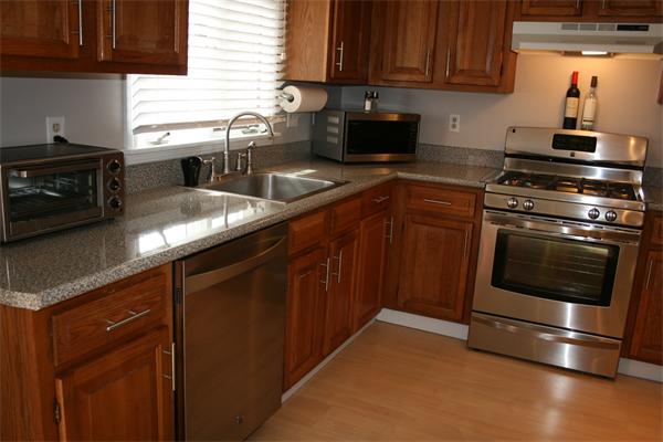 8 Apple Ridge Road, Unit 6 Maynard, MA 01754 - Photo 6 of 30 a kitchen with granite countertop a stove and a sink