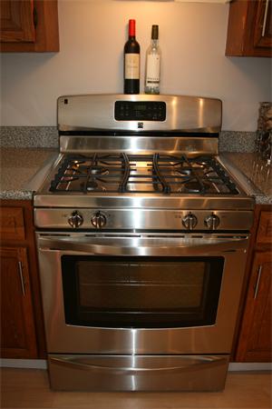 8 Apple Ridge Road, Unit 6 Maynard, MA 01754 - Photo 7 of 30 a stove top oven sitting inside of a kitchen