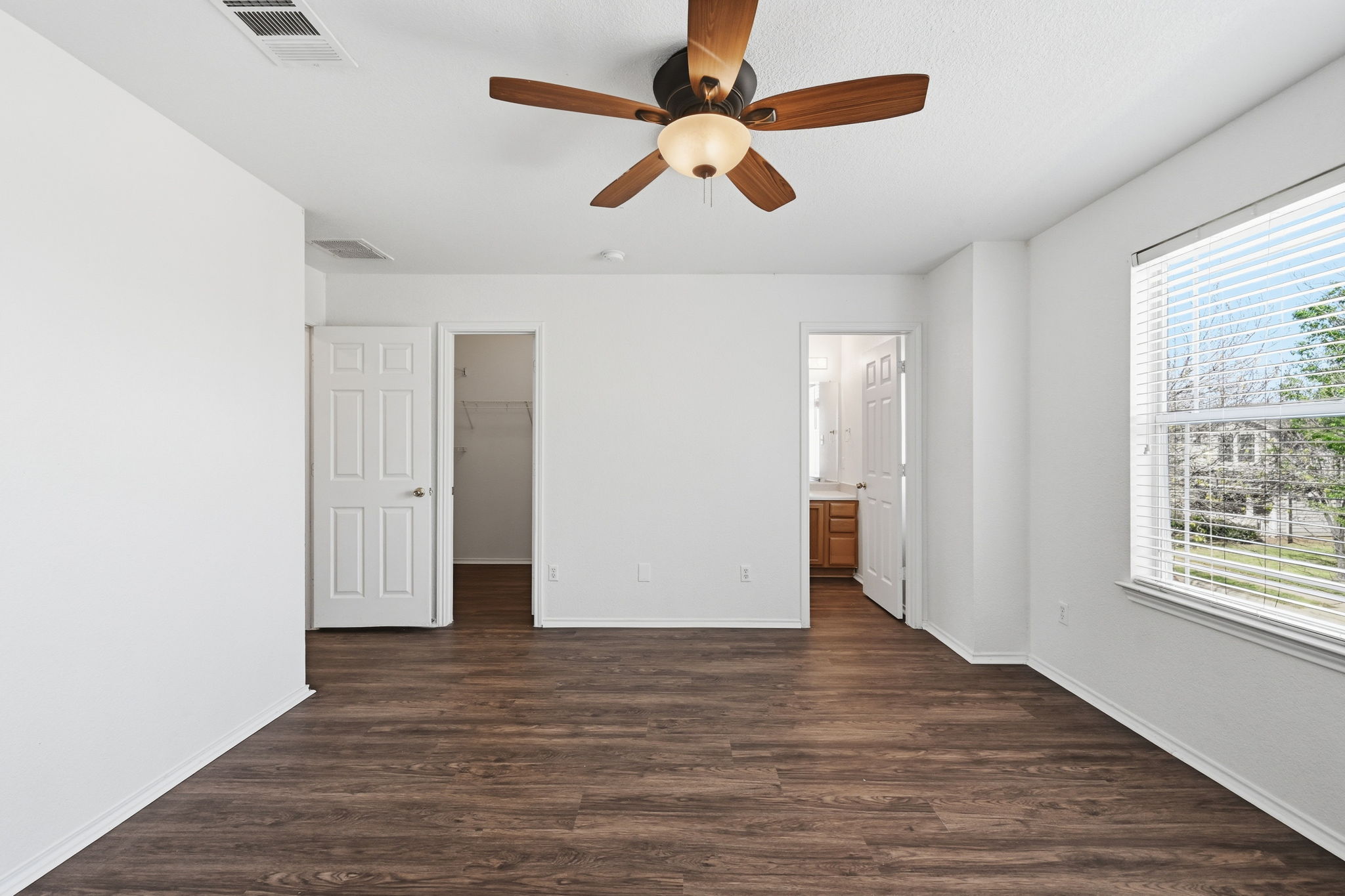1805 Lost Maples Loop Cedar Park, TX 78613 - Photo 14 of 31 an empty room with wooden floor chandelier fan and windows