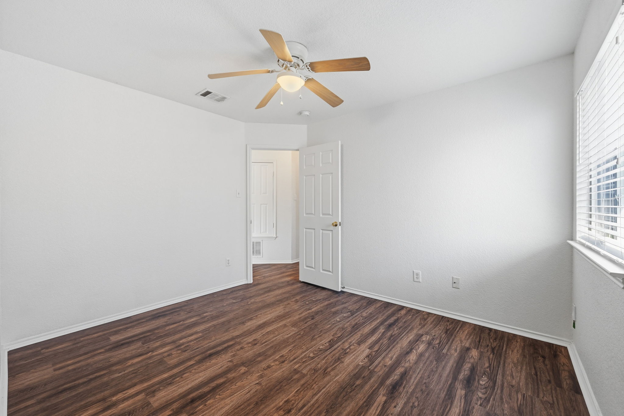 1805 Lost Maples Loop Cedar Park, TX 78613 - Photo 16 of 31 an empty room with wooden floor and windows