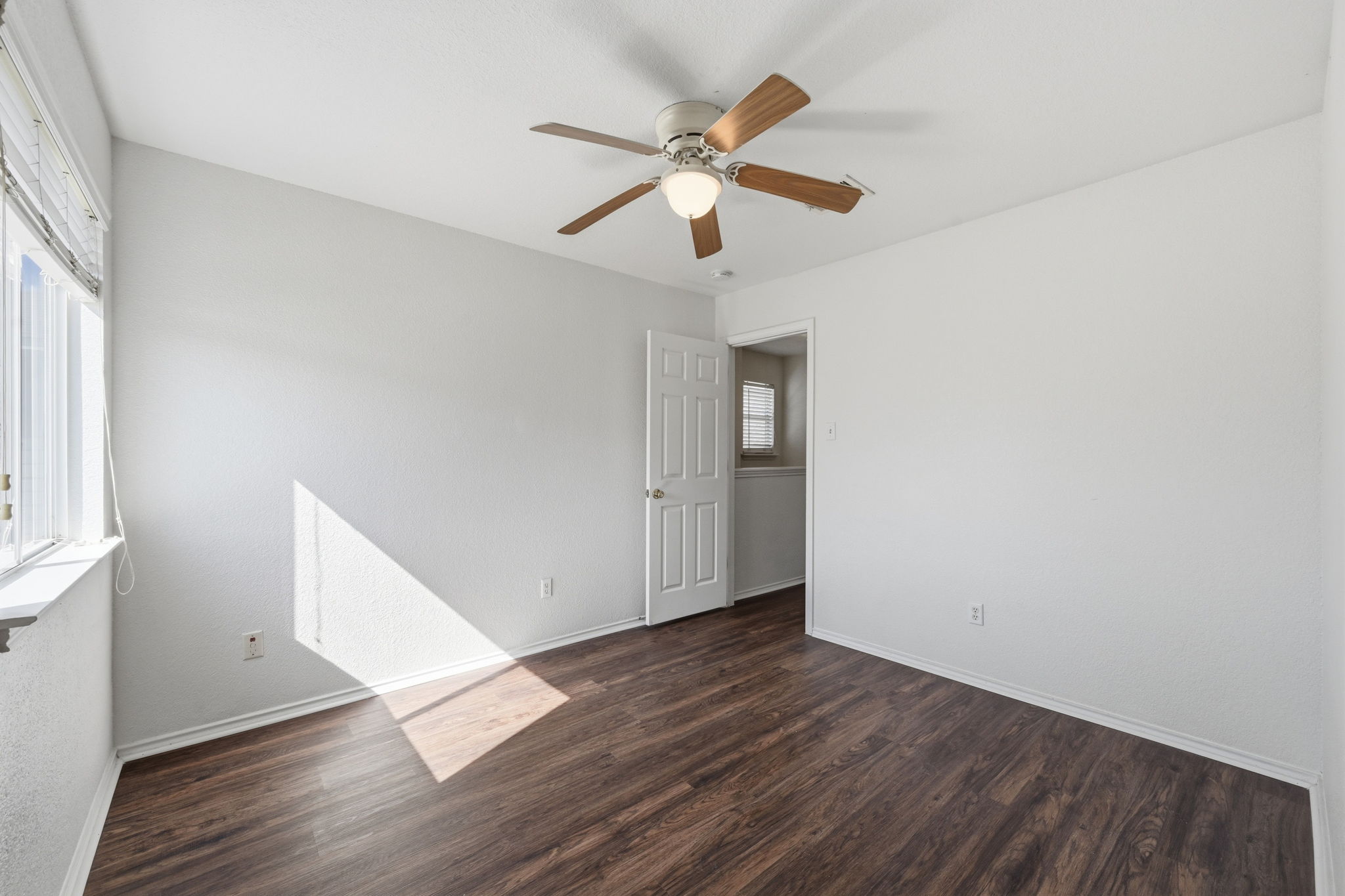 1805 Lost Maples Loop Cedar Park, TX 78613 - Photo 18 of 31 an empty room with wooden floor fan and windows