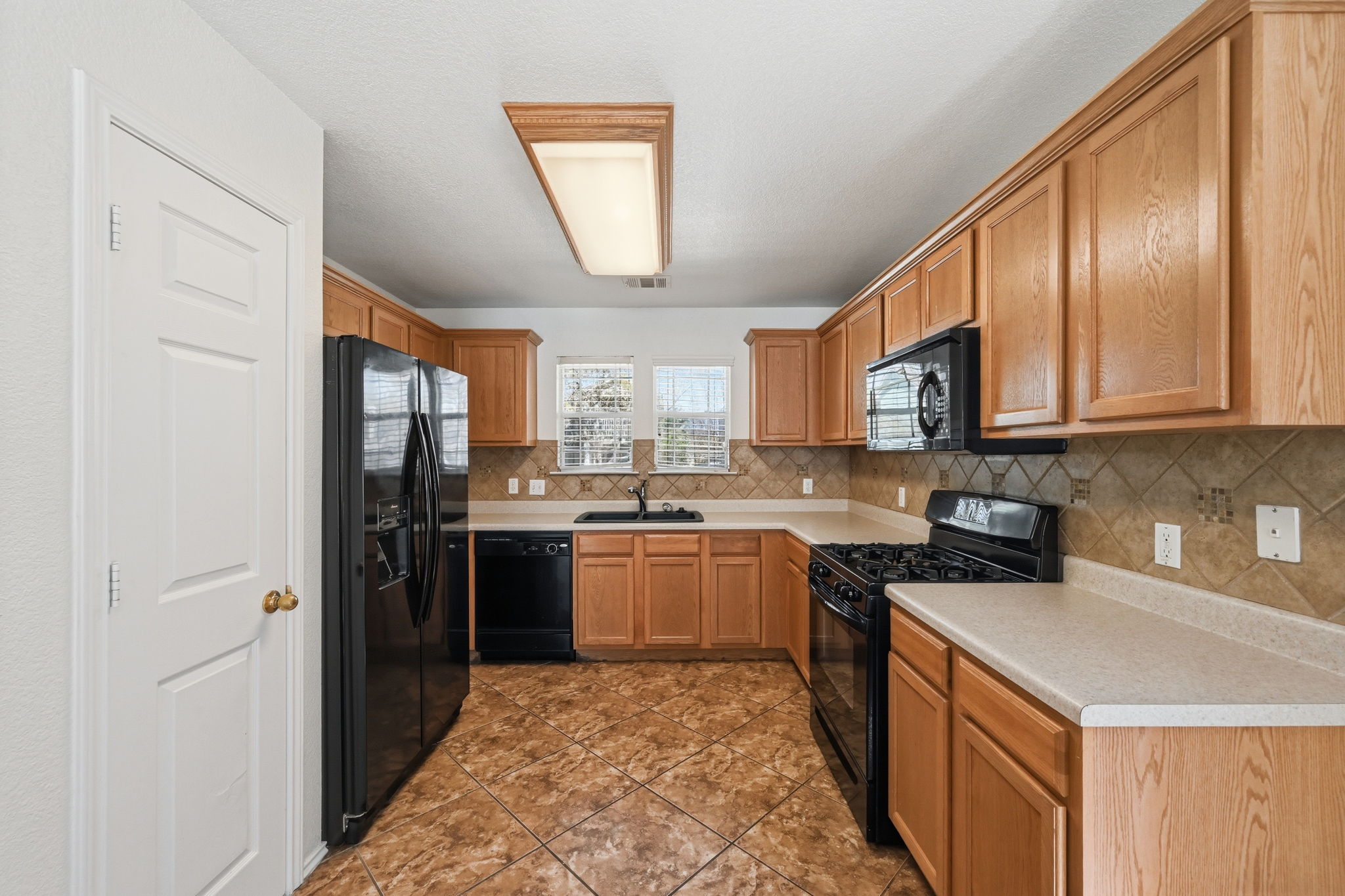 1805 Lost Maples Loop Cedar Park, TX 78613 - Photo 7 of 31 a kitchen with a sink stove and cabinets