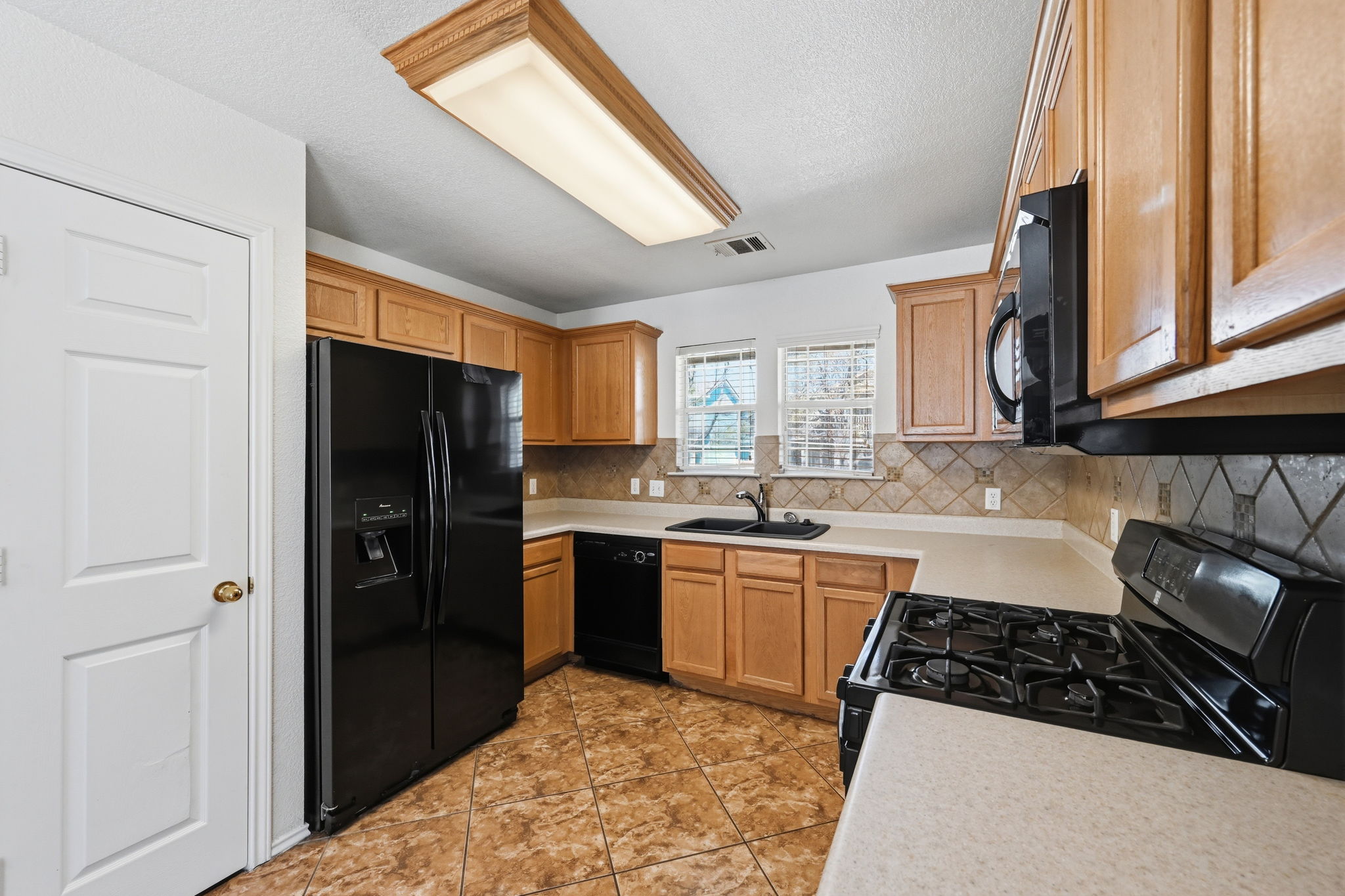 1805 Lost Maples Loop Cedar Park, TX 78613 - Photo 8 of 31 a kitchen with granite countertop a refrigerator stove top oven and sink