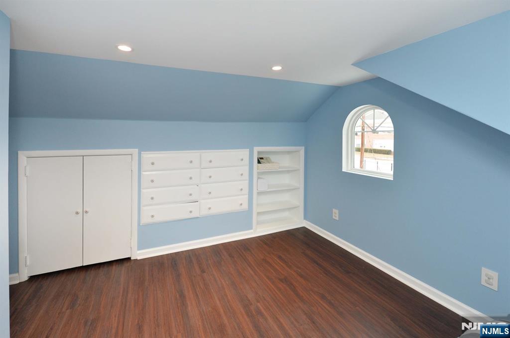 675 Center Street Oradell, NJ 07649 - Photo 19 of 29 an empty room with wooden floor closet and windows