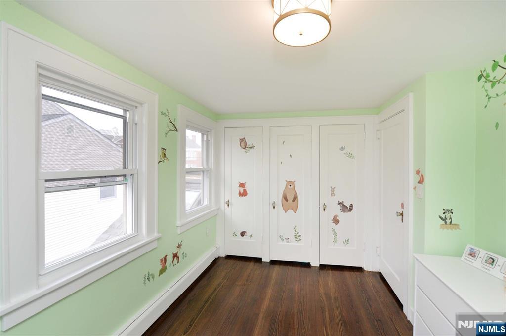 675 Center Street Oradell, NJ 07649 - Photo 20 of 29 a view of an empty room with a window and wooden floor