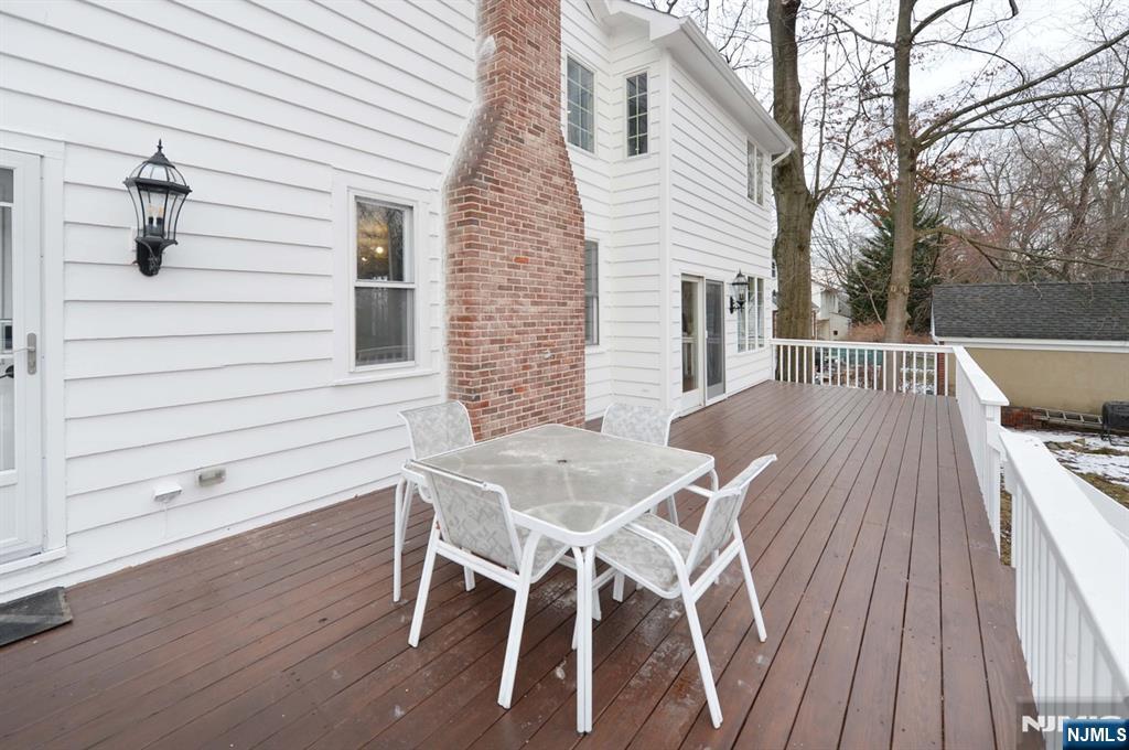 675 Center Street Oradell, NJ 07649 - Photo 28 of 29 a view of a patio with table and chairs with wooden floor and fence