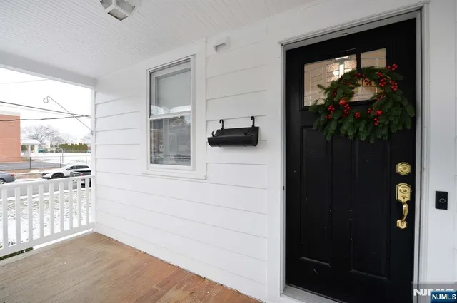 a view of a hallway with wooden floor and a cabinet