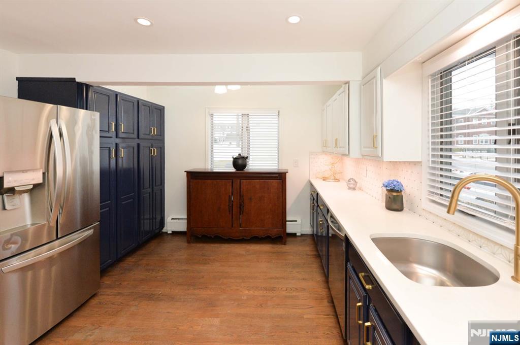 675 Center Street Oradell, NJ 07649 - Photo 4 of 29 a kitchen with stainless steel appliances granite countertop a sink stove and refrigerator