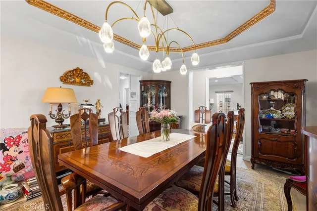 a dining room with furniture and chandelier