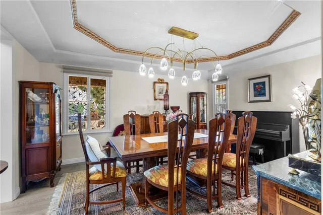a view of a dining room with furniture and chandelier