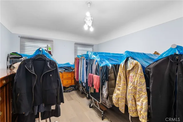 a view of walk in closet with clothes and shoes