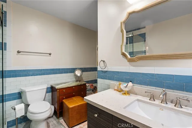 a bathroom with a sink toilet and mirror