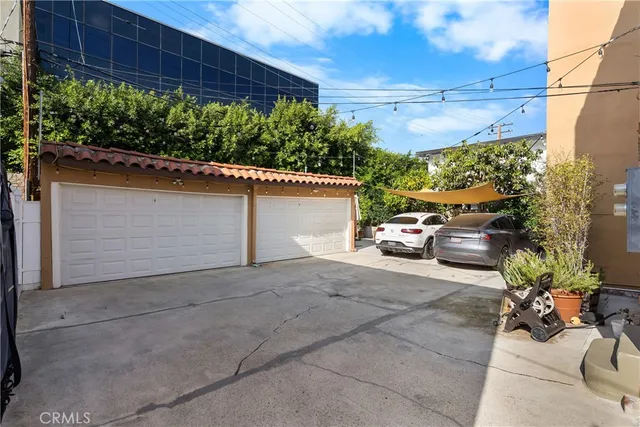 a view of a yard with potted plants