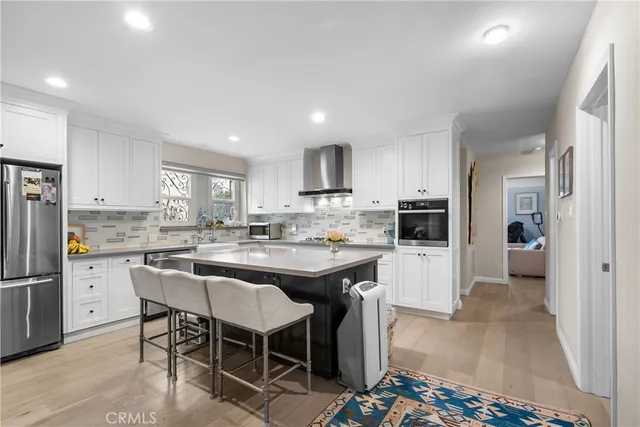 a kitchen with a sink and refrigerator