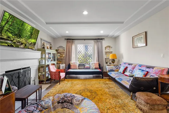a living room with patio fireplace furniture and a large window