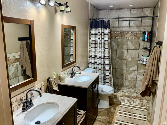 76 Highway 118 Monroe, UT 84754 - Photo 68 of 76 Bathroom featuring a shower stall, a textured wall, and two vanities