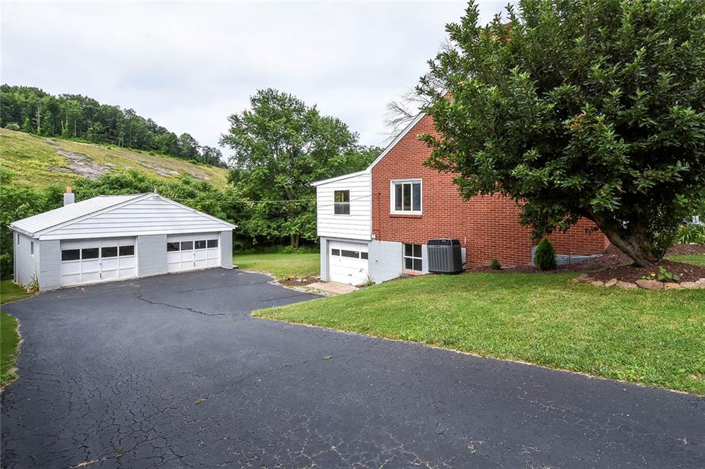 1009 Arona Road New Stanton, PA 15672 - Photo 3 of 24 3 car garage. One integral adn 2.5 wide plus deep detached garage make this home perfect for a home-based business that need the extra garage space. Plenty of parking in this oversized driveway for company!