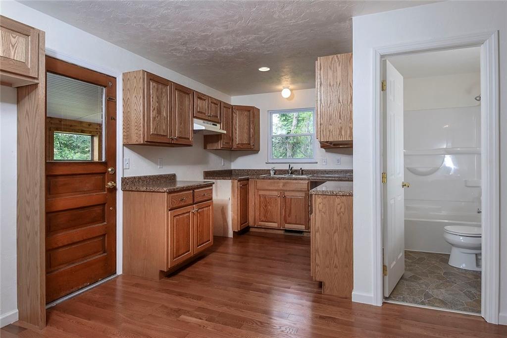 1009 Arona Road New Stanton, PA 15672 - Photo 6 of 24 The kitchen is completely new down to the flooring, lighting, new plaster, solid oak cabinets, sink & faucet. Seller is offering a very generous $2500 credit at the closing so you can pick the appliances you like best. Refrigerator will be to left of door to the 3 season room and to the right a hallway to the bath and master bedroom.