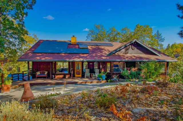 a patio with a table and chairs under an umbrella