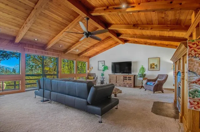 a very nice looking dining room with a large window and a wooden table