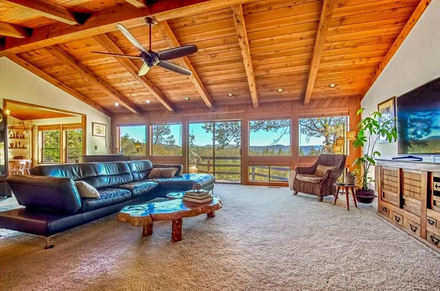 a dining room with furniture a large window and a rug