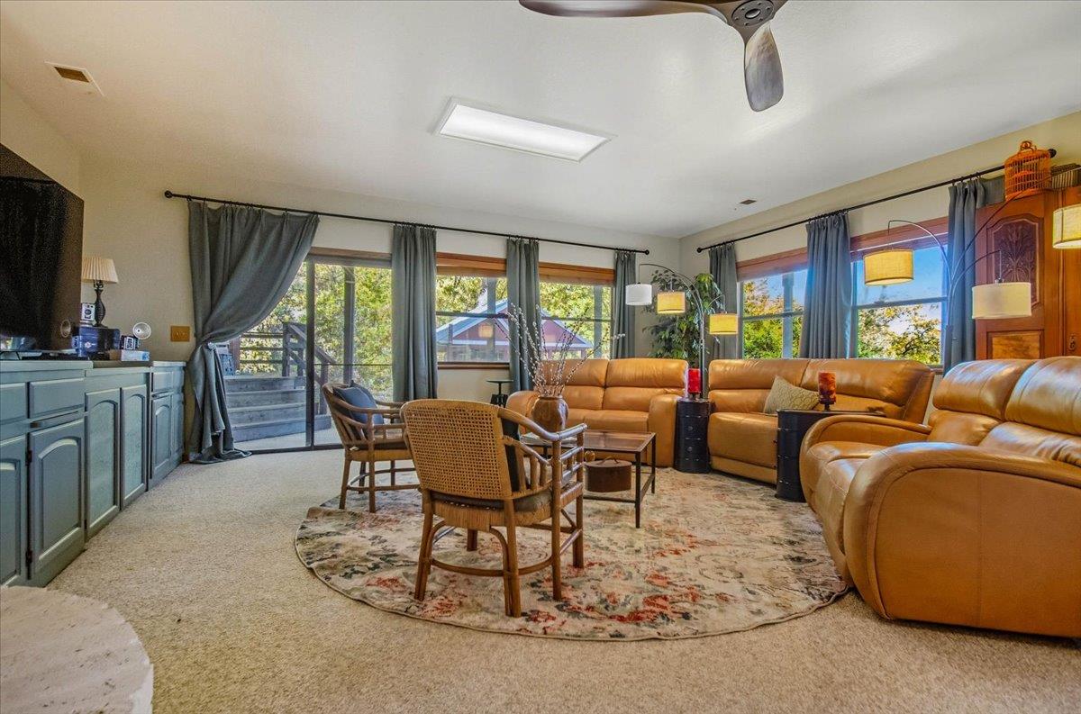 5617 Indian Hills Road Murphys, CA 95247 - Photo 20 of 80 a dining room with furniture a large window and a rug