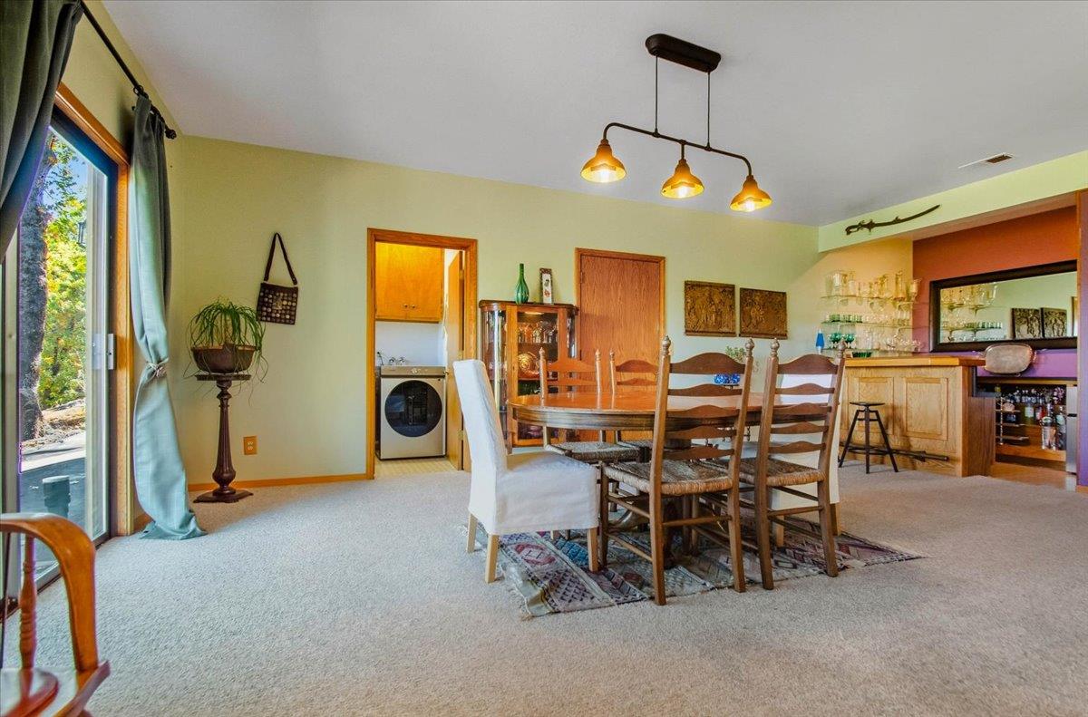 5617 Indian Hills Road Murphys, CA 95247 - Photo 22 of 80 a view of a dining room with furniture and chandelier
