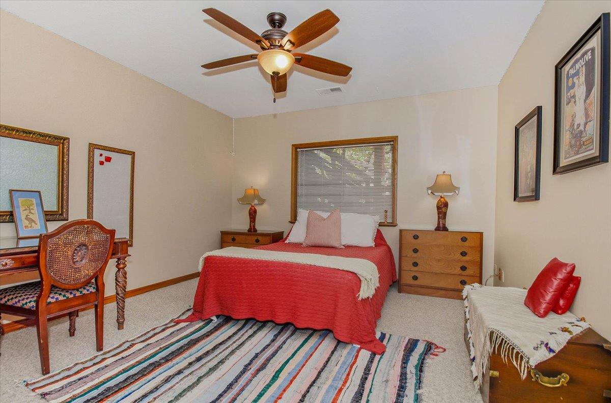 5617 Indian Hills Road Murphys, CA 95247 - Photo 25 of 80 a bedroom with two beds and a chandelier