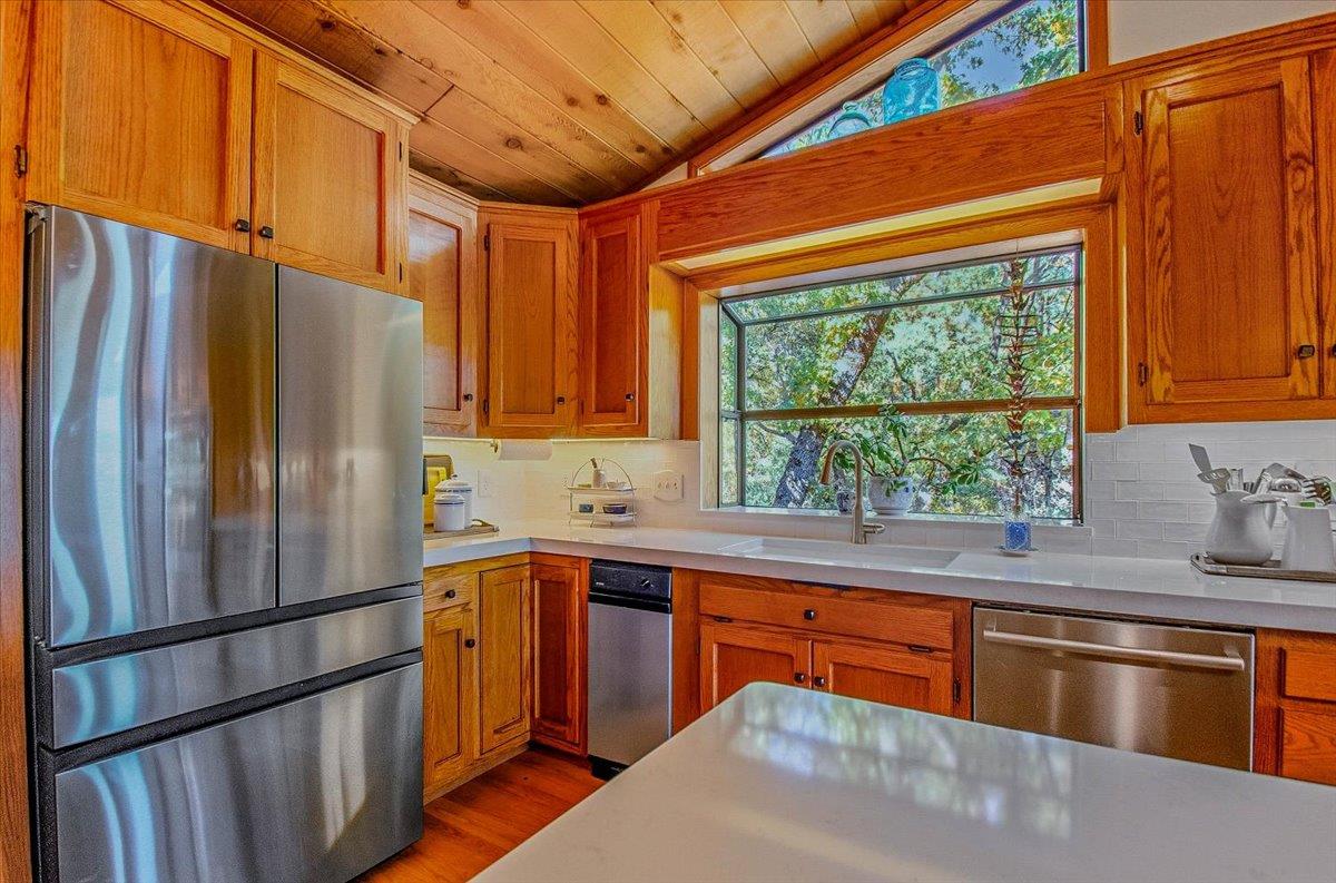 5617 Indian Hills Road Murphys, CA 95247 - Photo 44 of 80 a kitchen with stainless steel appliances granite countertop a refrigerator a sink dishwasher a stove and a refrigerator with wooden floor