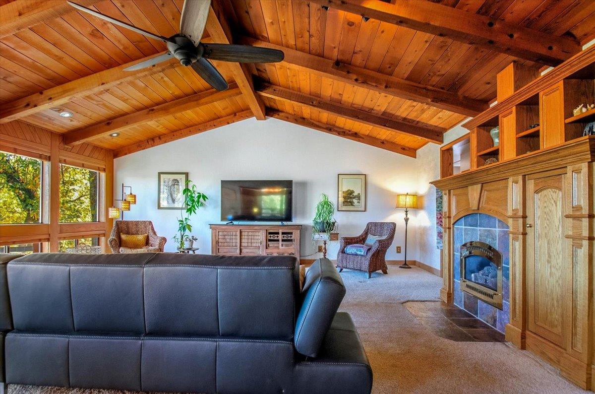 5617 Indian Hills Road Murphys, CA 95247 - Photo 45 of 80 a living room with furniture a fireplace and a flat screen tv