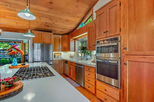 a view of a dining room with furniture large windows and wooden floor