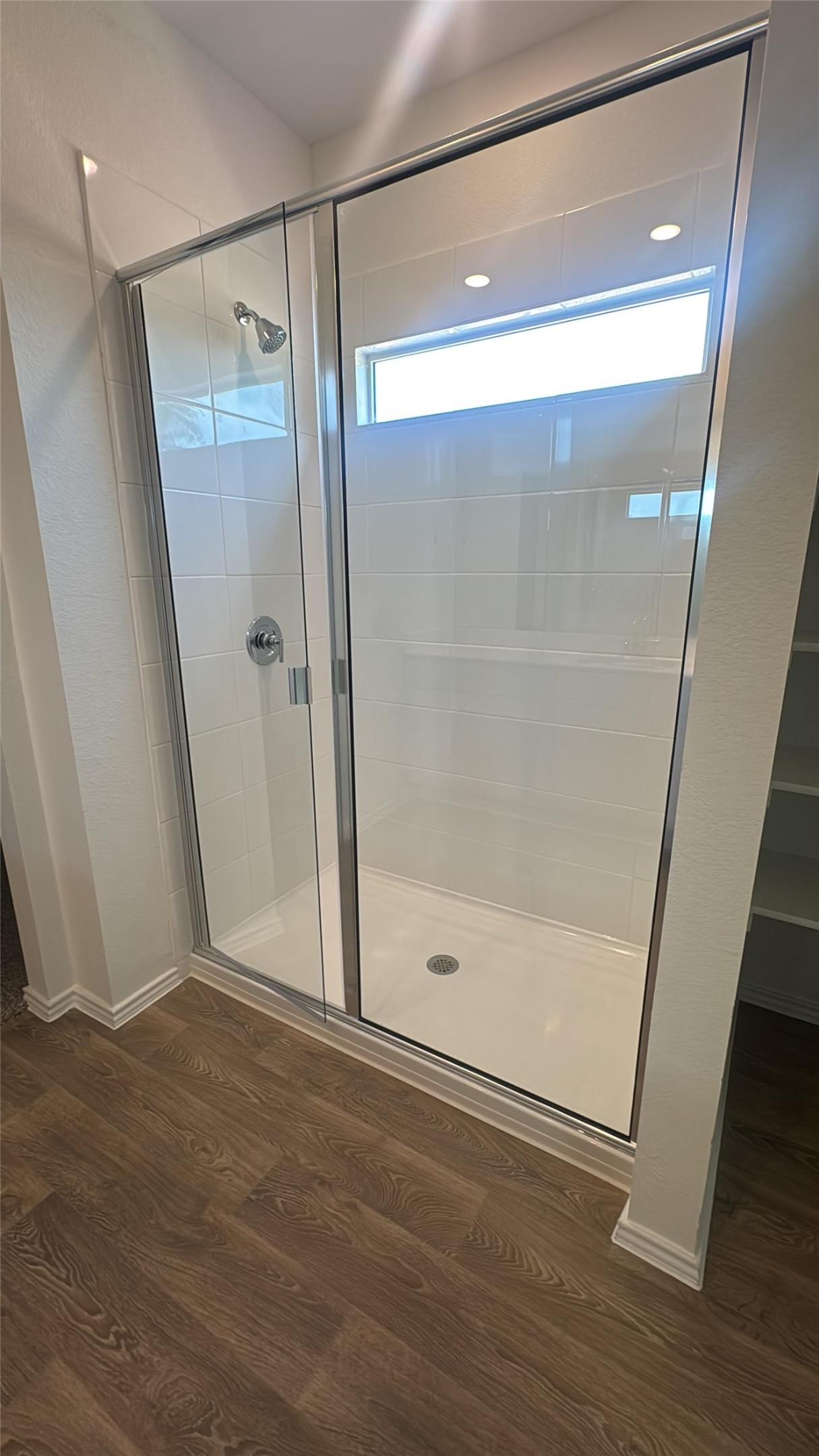 174 Balmorhea Street Kyle, TX 78640 - Photo 25 of 29 A well-lit, contemporary shower enclosure offers a refreshing daily retreat.