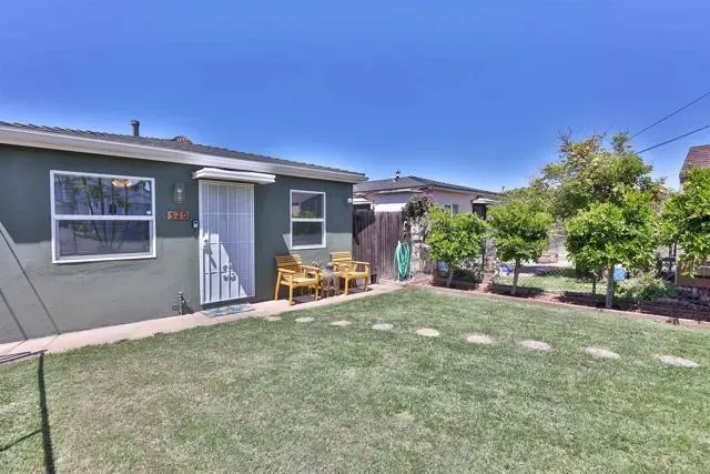 a view of an house with backyard porch and furniture