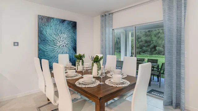 a dining room with furniture and wooden floor