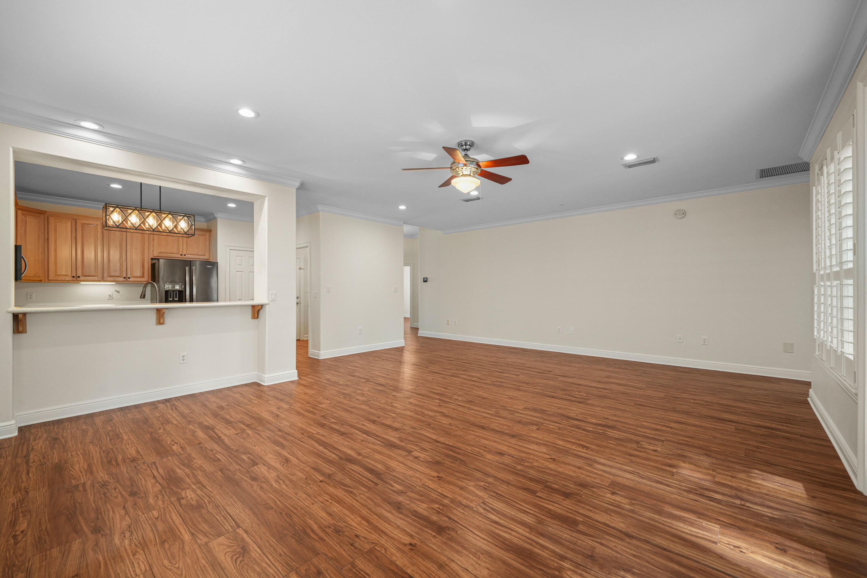 4116 Callaway Drive Niceville, FL 32578 - Photo 15 of 53 a view of kitchen and empty room with wooden floor