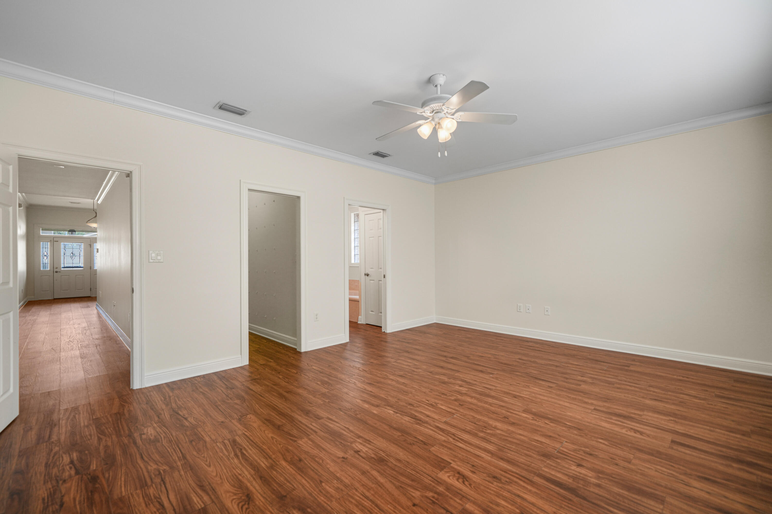 4116 Callaway Drive Niceville, FL 32578 - Photo 24 of 53 a view of an empty room with wooden floor