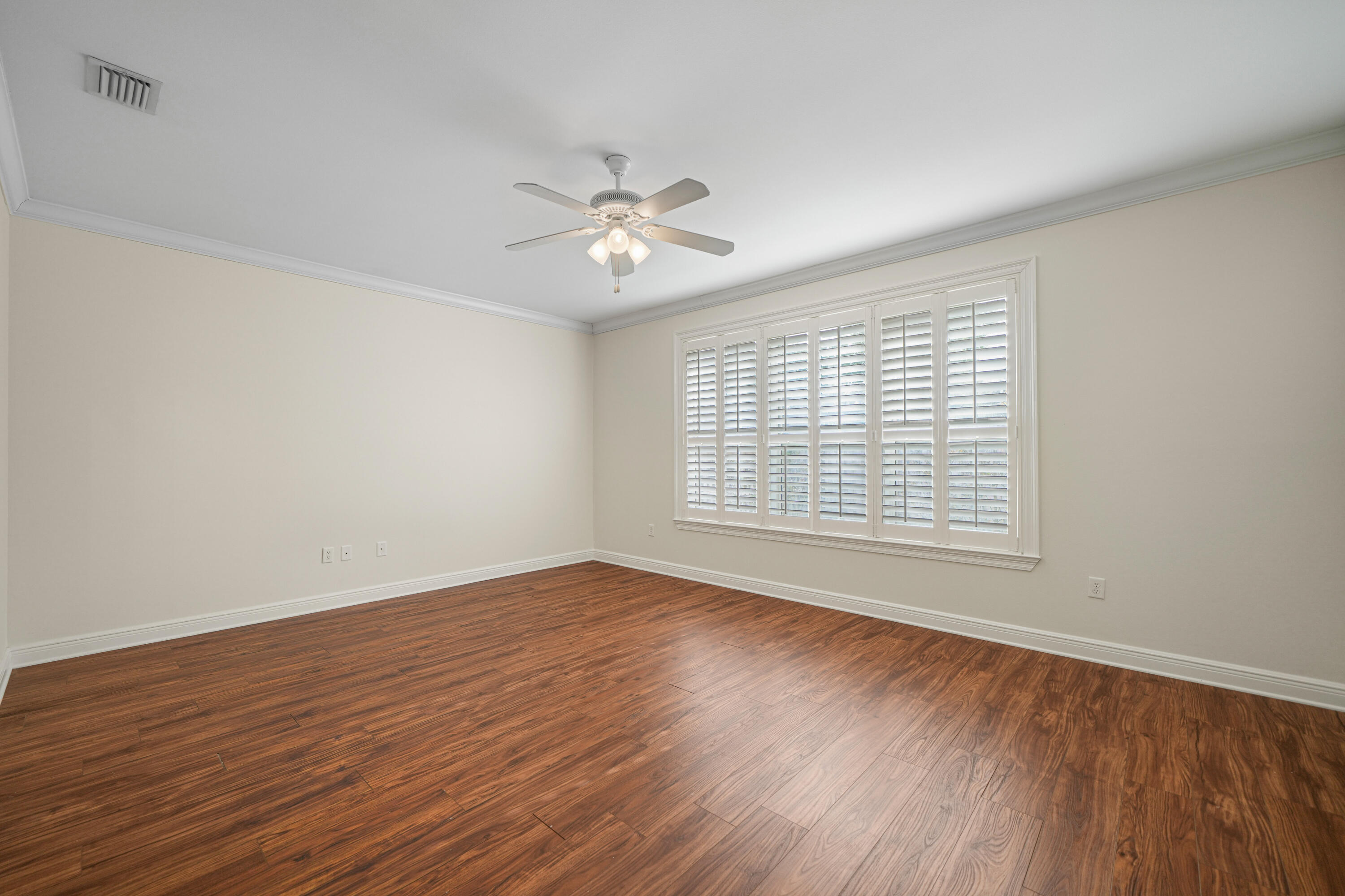 4116 Callaway Drive Niceville, FL 32578 - Photo 26 of 53 a view of an empty room with wooden floor and a window