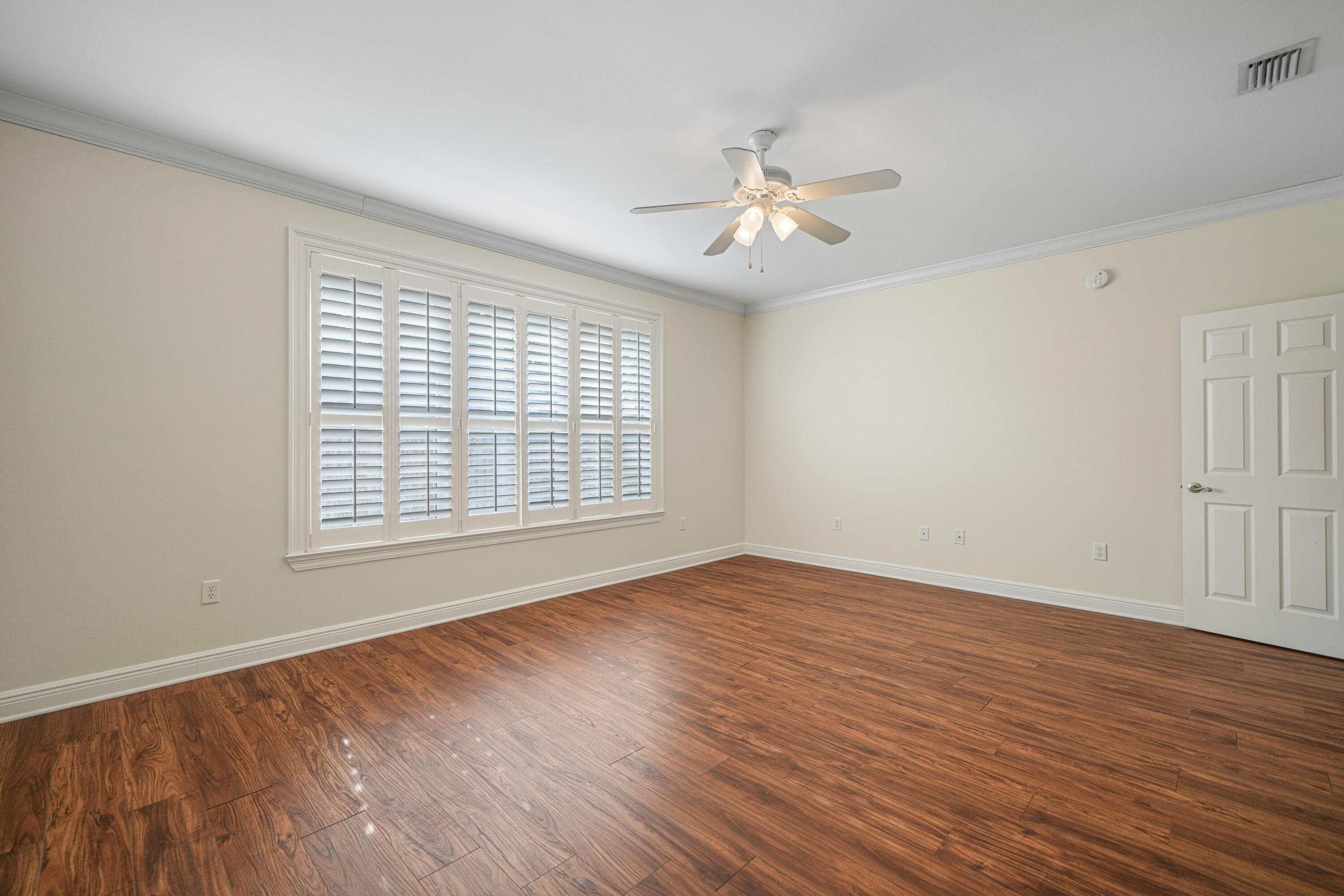 4116 Callaway Drive Niceville, FL 32578 - Photo 27 of 53 a view of an empty room with wooden floor and a window