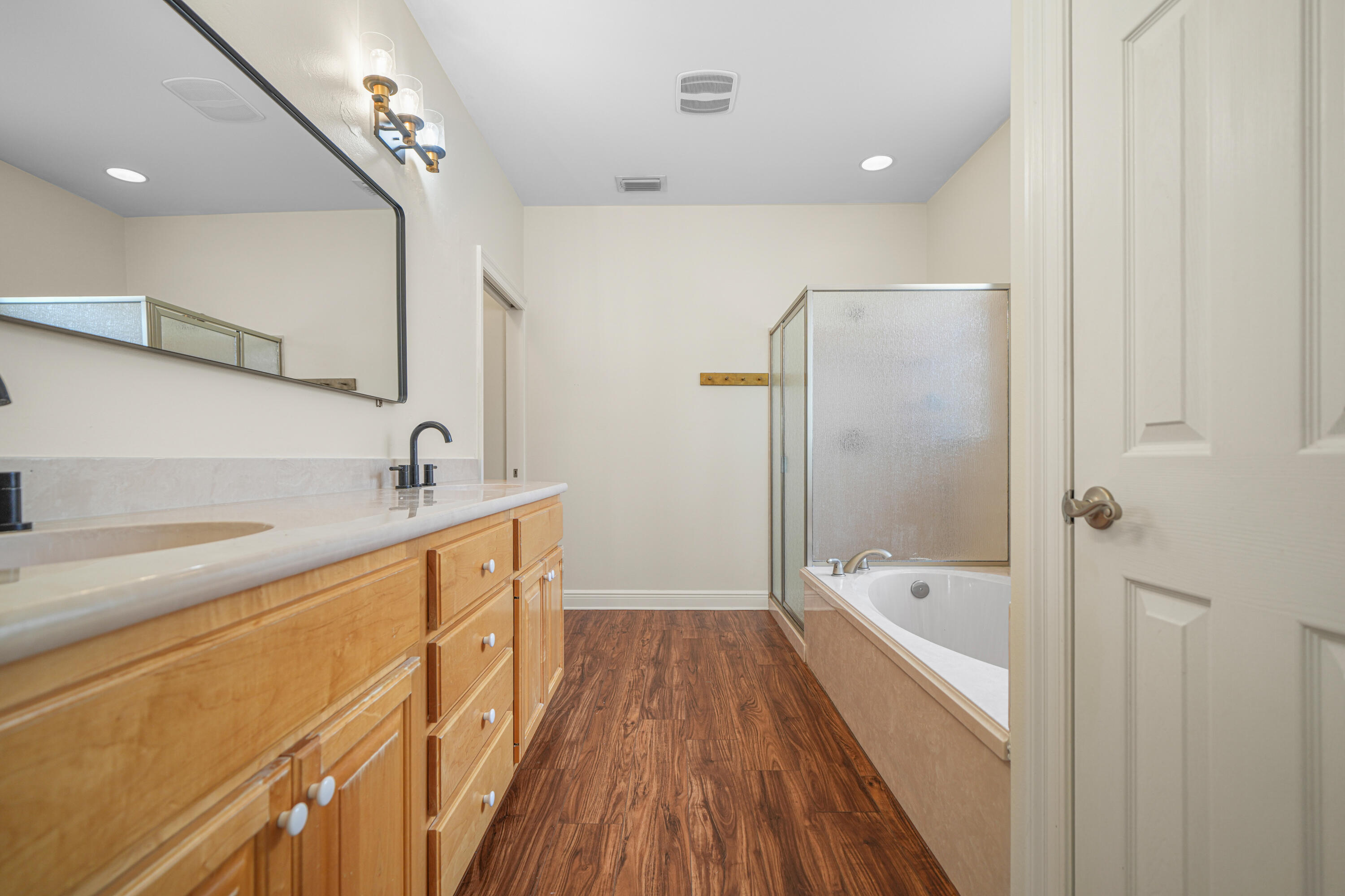 4116 Callaway Drive Niceville, FL 32578 - Photo 30 of 53 a bathroom with a bathtub a sink and a large mirror